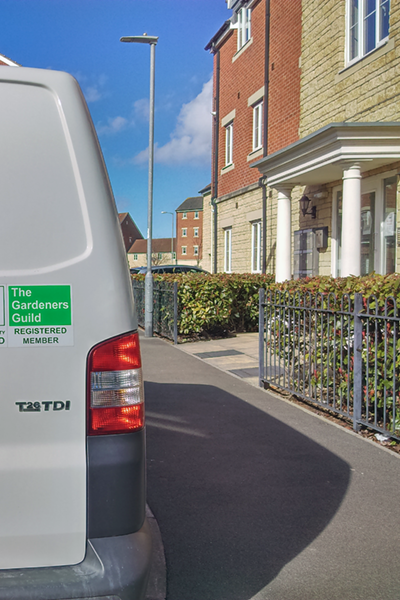 Local gardener's van featuring the official logo of The Gardeners Guild and other vehicle stickers only available to members of The Gardeners Guild